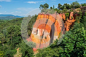 Reddish rock formations made of ocher near Rousillon village, Provence photo