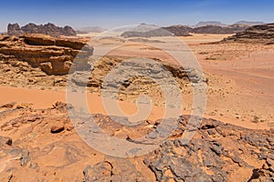 Reddish sand and rock landscapes in the desert of Wadi Rum, southern Jordan