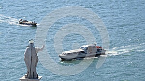 Redeemer Statue on roof of St George Church blessing boats on water, transport