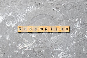 Redemption word written on wood block. redemption text on cement table for your desing, concept