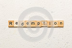 redemption word written on wood block. redemption text on cement table for your desing, concept