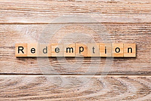 Redemption word written on wood block. redemption text on wooden table for your desing, concept