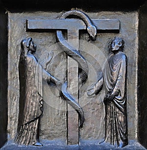 The redemptive death of Christ depicted in the emblem of the bronze serpent, door of the Grossmunster church in Zurich photo