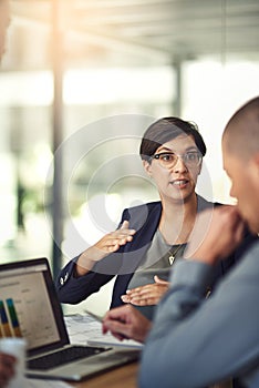 Redesigning their strategy. colleagues having a discussion in a boardroom.