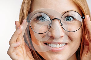 Redhair girl with happy expression in eyeglasses