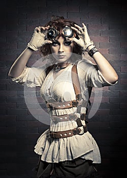 Redhair girl with steampunk goggles