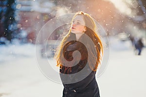 Redhair girl walks in the winter. photo
