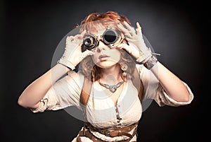 Redhair steampunk woman with goggles