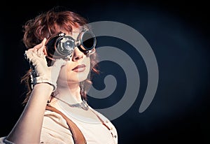 Redhair steampunk woman with goggles photo