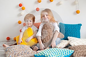 Redhaired children among pillows