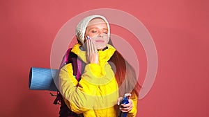 Redhaired ginger woman in pink studio background applying sunscreen sun cream sunblock