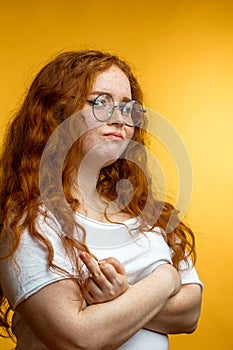 Redhaired woman with negative human facial expression.