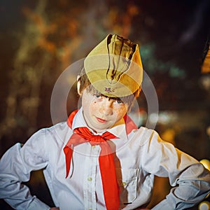 Redhead attractive boy dressed like soviet pioneer with red tie