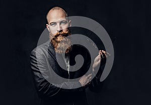 Redhead bearded male in a suit.