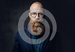 Redhead bearded male in a suit.