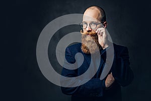 Redhead bearded male in a suit.