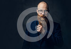 Redhead bearded male in a suit.