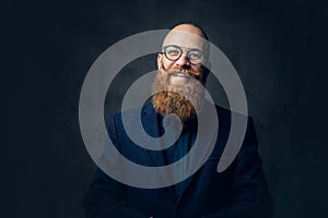 Redhead bearded male in a suit.