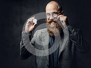 Redhead bearded male in a suit.