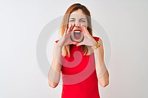 Redhead businesswoman wearing elegant red dress standing over isolated white background Shouting angry out loud with hands over