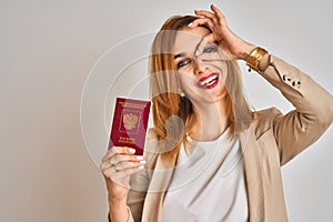 Redhead caucasian business woman holding passport of Russia over isolated background with happy face smiling doing ok sign with