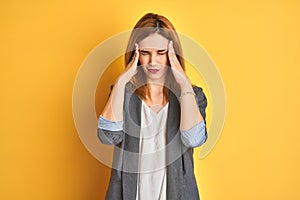Redhead caucasian business woman over yellow isolated background with sad expression covering face with hands while crying