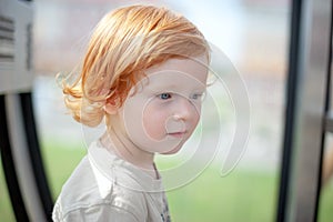 Redhead child thinks and looks into the void