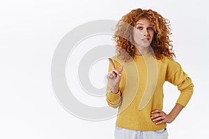 Redhead curly bossy woman in yellow sweater give warning, restrain friend from bad action, shaking finger displeased