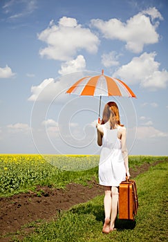 Redhead enchantress at rapeseed field.