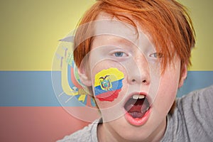 Redhead fan boy with ecuadorian flag painted on his face