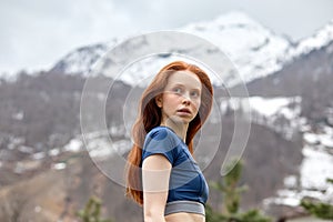 redhead female having rest after the run, workout. relaxed lady in sportswear in nature