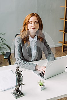 Redhead female lawyer looking at camera