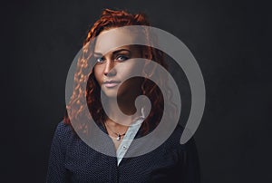 Redhead female supervisor dressed in an elegant suit.