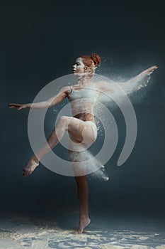 Redhead fitness girl female adult woman dancer in dust