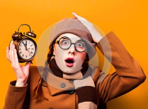 Redhead girl with alarm clock