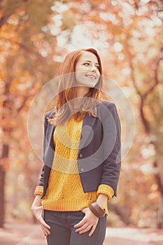 Redhead girl at autumn outdoor