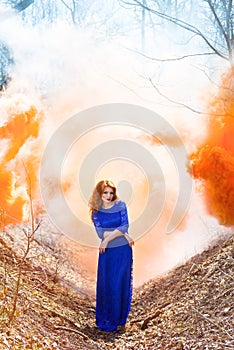 Redhead girl on a background of orange mist