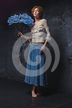 Redhead girl with big blue flower