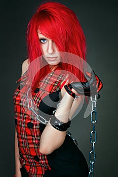 Redhead girl bounded by chains