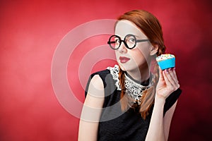 Redhead girl with cupcake