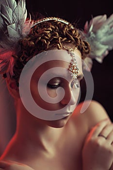 Redhead girl in feather headdress