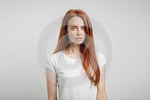 Redhead girl with healthy freckled skin looking at camera