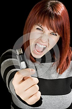 Redhead girl holding a flash drive at camera