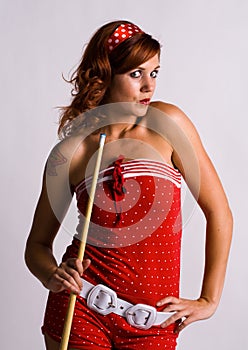 Redhead girl holding a pool cue