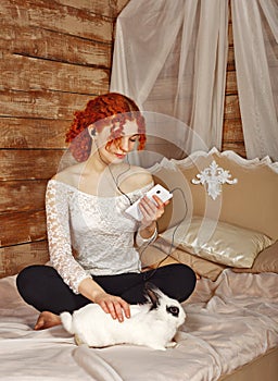 Redhead girl listening to music on headphones