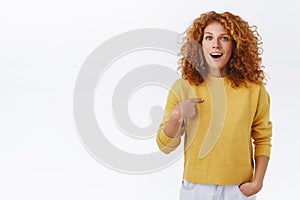 Redhead girl looking surprised and pointing herself as hearing she won, woman gasping wondered, got promoted or picked