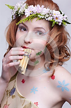 Redhead girl with panflute photo