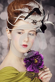 Redhead girl with Rococo hair style and flower at vintage background. Photo in old style. photo