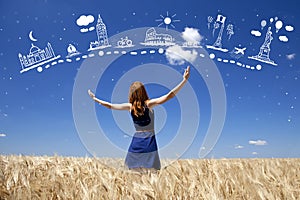 Redhead girl at wheat field in summer day.