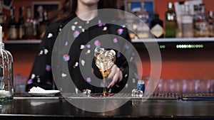 Redhead girl Young adult woman bartender prepares mixes paper airplane cocktail bar Pours ice bells